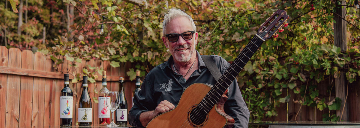 Paul Cullen with a guitar and wine
