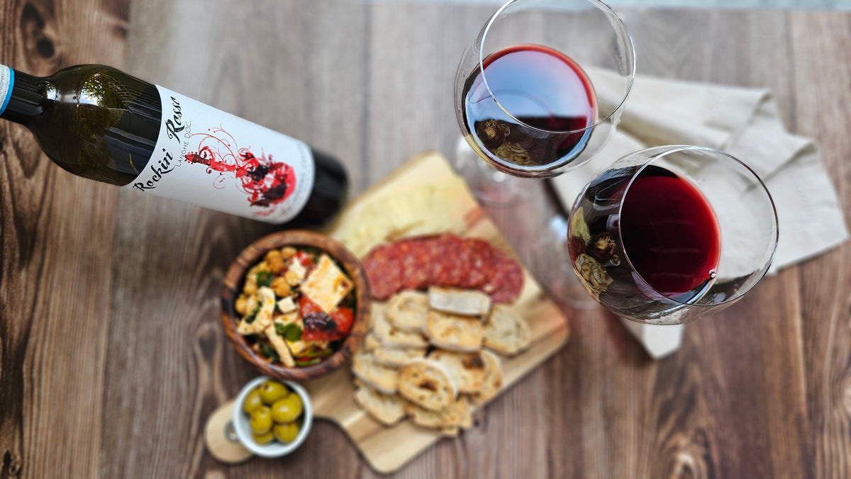 Paul Cullen Rosso, charcuterie and two glasses of wine arranged for a shared table